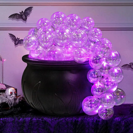 Black cauldron with purple LED lights against a Halloween-themed background
