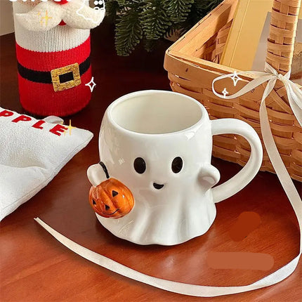 White ghost-shaped mug with a pumpkin on a wooden surface, surrounded by festive decorations.
