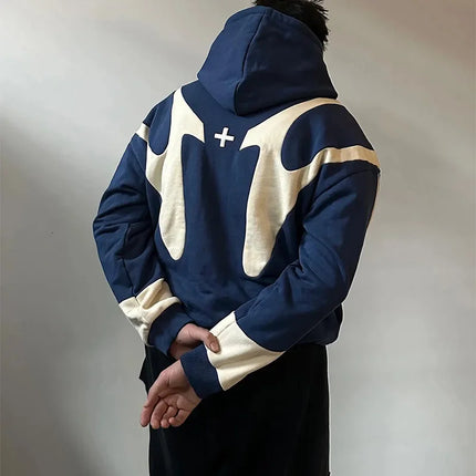 Person wearing a blue and white hoodie with a logo on a plain background
