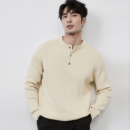 Man wearing a beige ribbed sweater against a white background