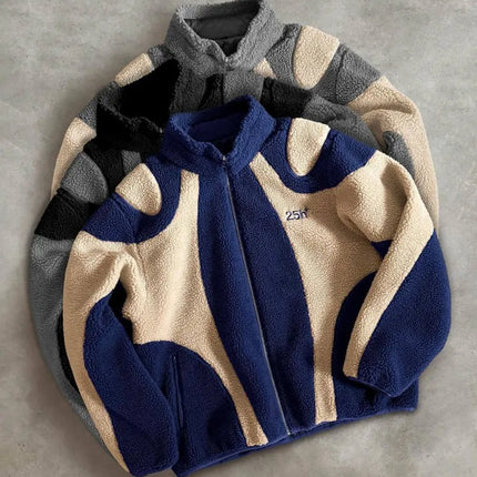 Three folded fleece jackets in blue, gray, and beige on a gray background