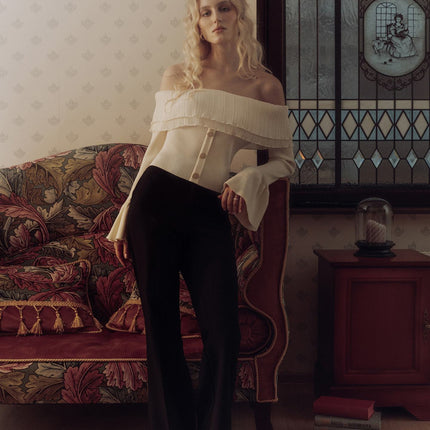 Elegante top con hombros descubiertos, volante plisado y mangas acampanadas