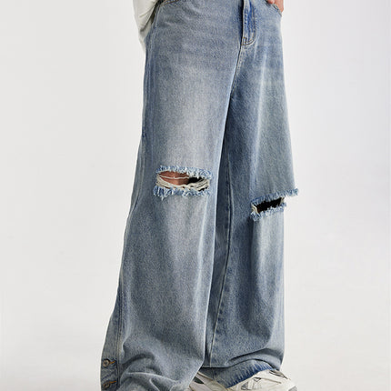 men's wide-leg jeans, ripped denim, vintage wash jeans, baggy streetwear jeans, loose-fit jeans, trendy men's denim, casual street style, frayed knee jeans, urban fashion.