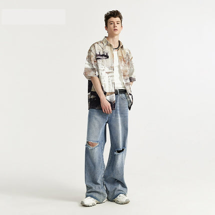 men's wide-leg jeans, ripped denim, vintage wash jeans, baggy streetwear jeans, loose-fit jeans, trendy men's denim, casual street style, frayed knee jeans, urban fashion.